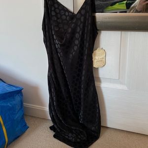 A polka dot black dress in the color black.